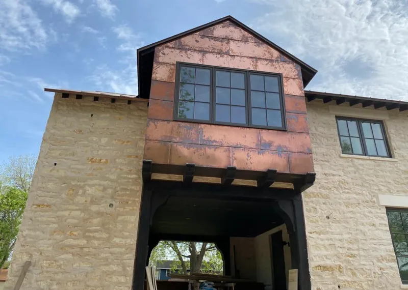 Copper metal panel facade on a stone building for Metal Roof Coating in Star